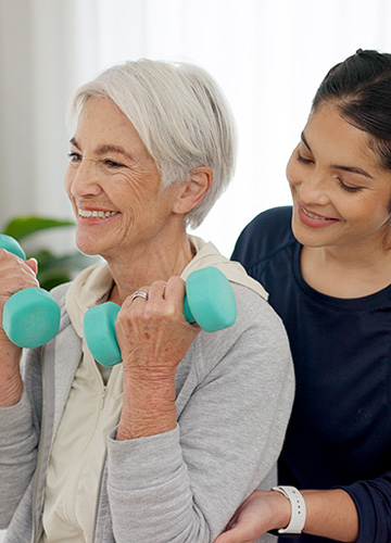 Physical Therapist helping elderly lady with PT